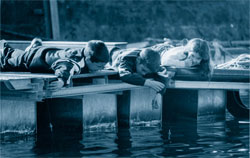Three children play lying on the ground